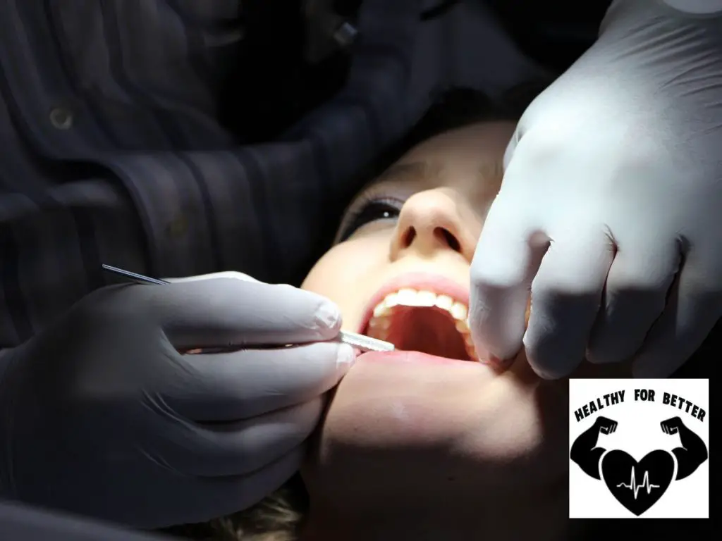 girl getting tooth extracted by dentist