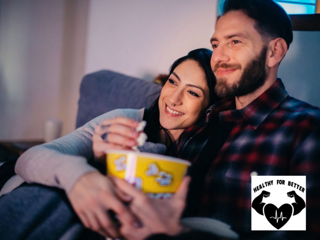 couple with popcorn eating and watching movie