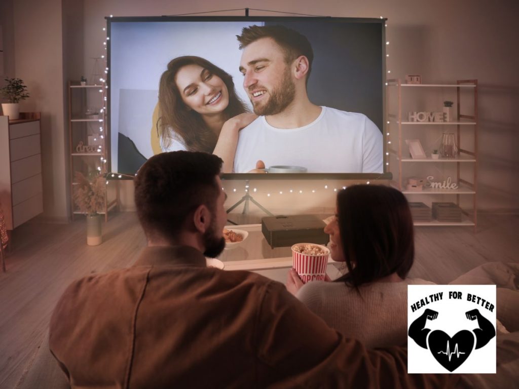 couple watching a movie on the big screen in living room